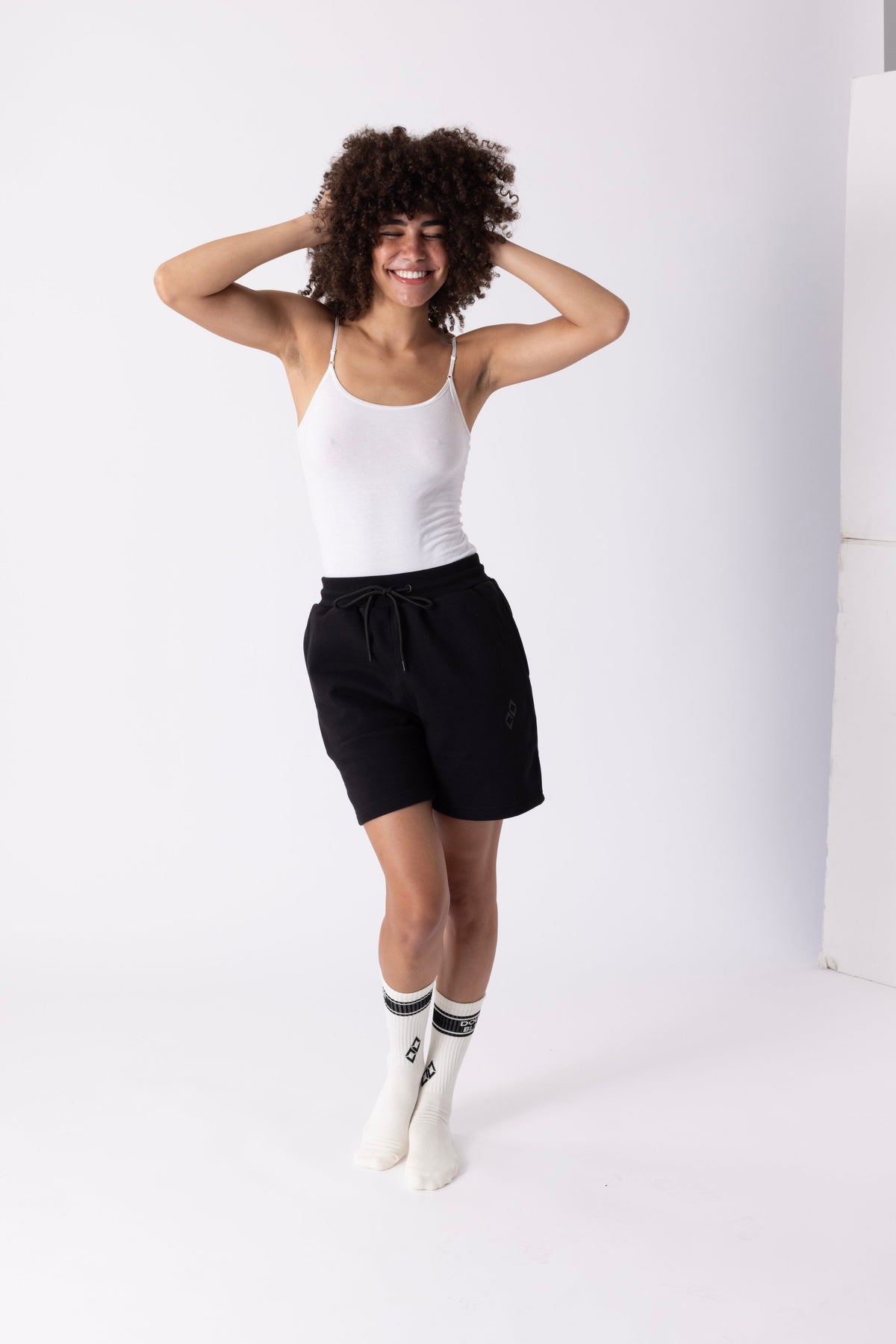 Model wearing Double Black Experts Only Sweatshorts in Black