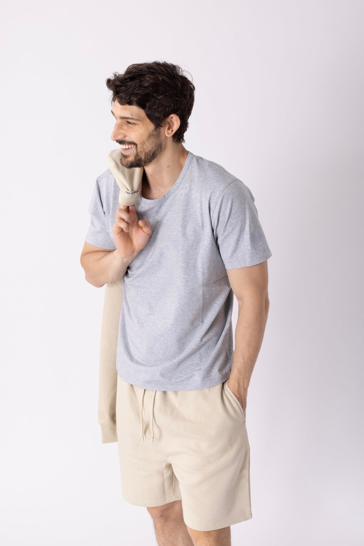 Model wearing Double Black Experts Only Sweatshorts in cream
