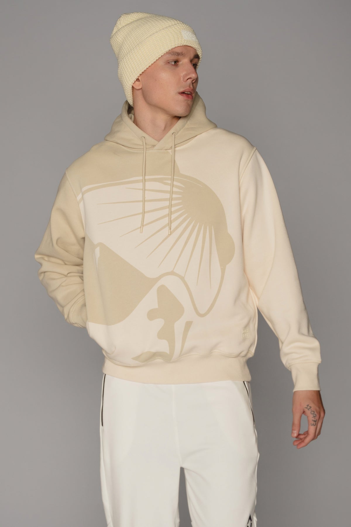 Model wearing Double Black On The Mountain Hoodie in cream