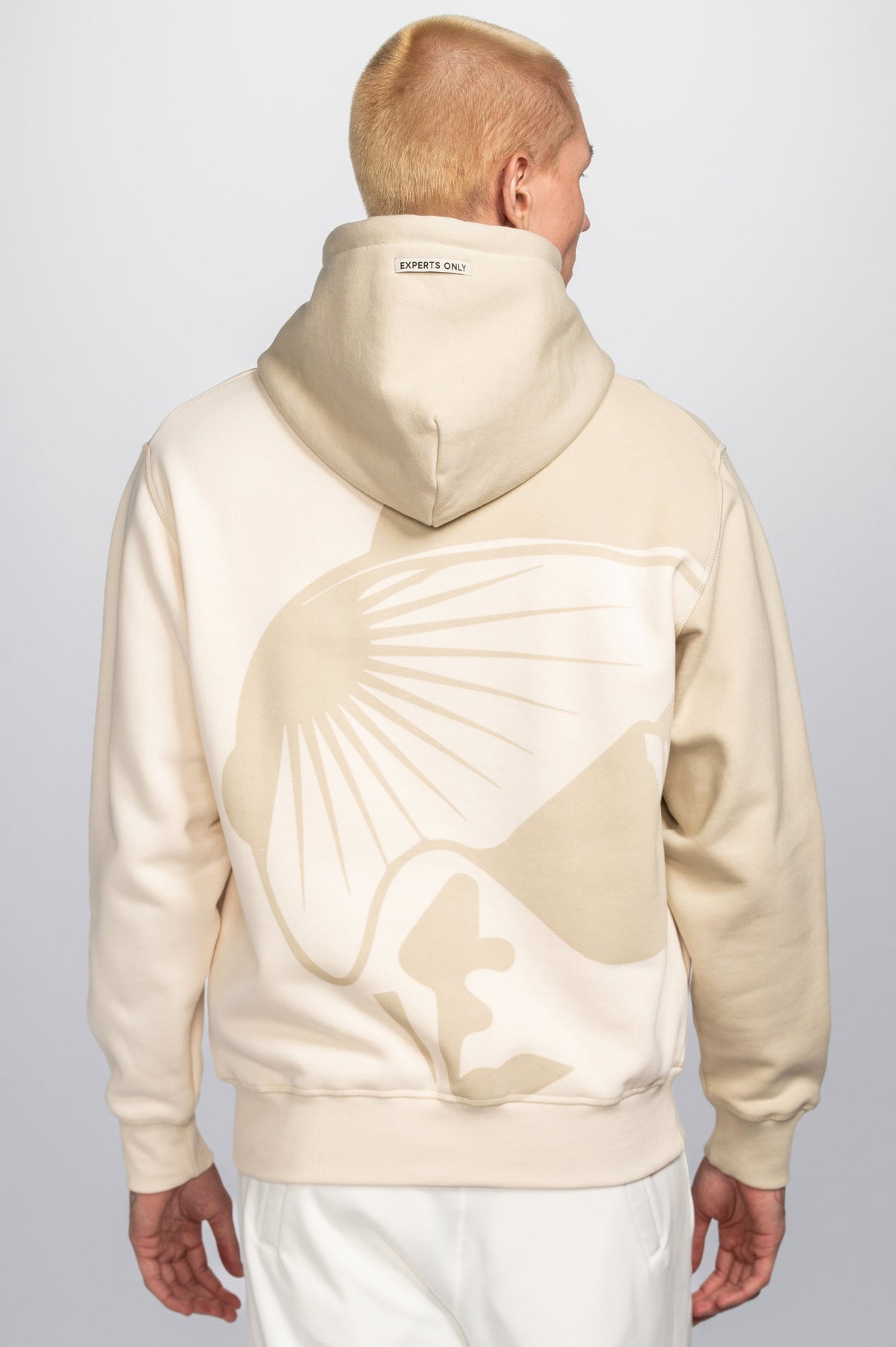 Model wearing Double Black On The Mountain Hoodie in cream back view