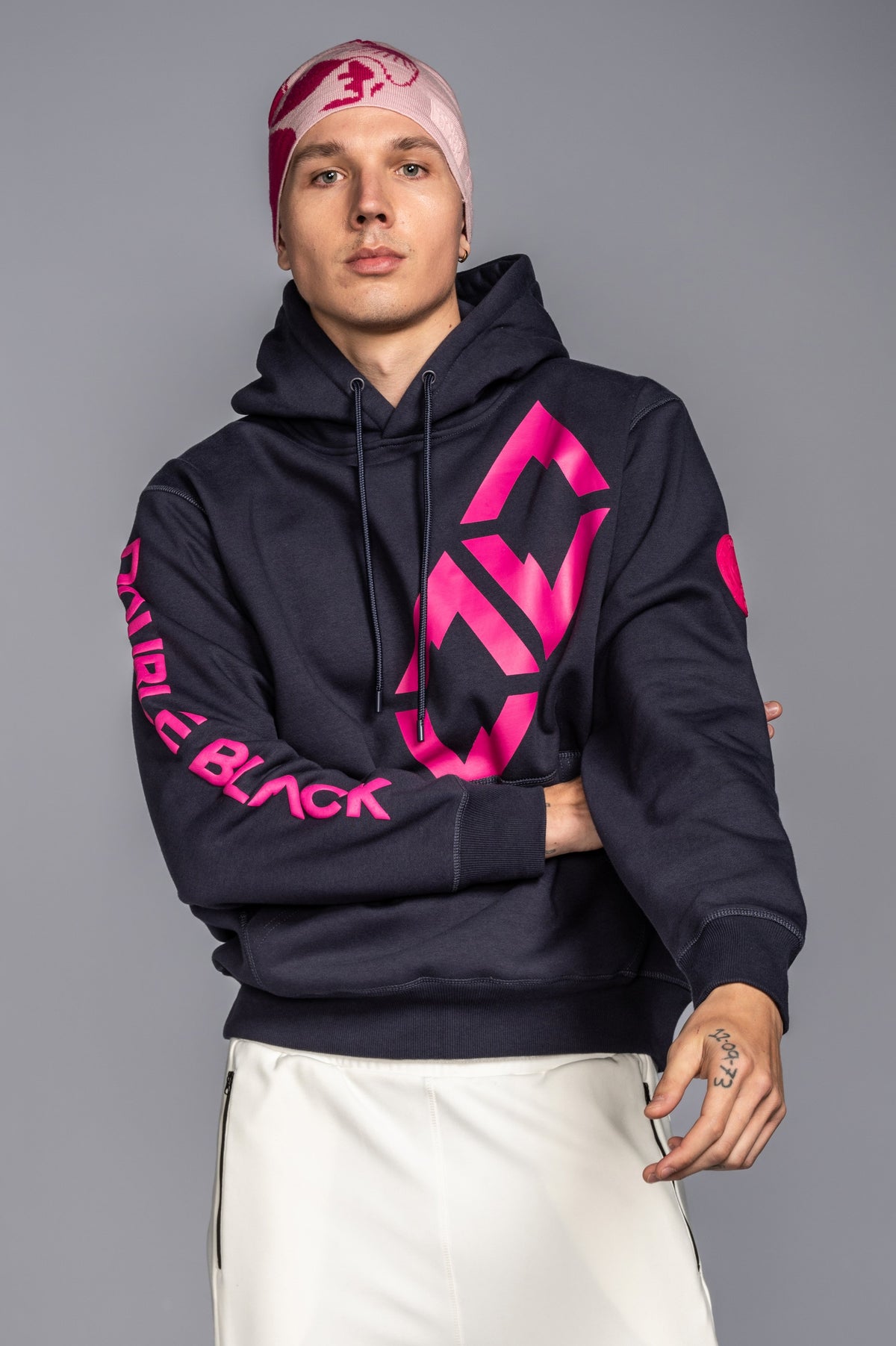 Model wearing Double Black Hoodie in navy and pink