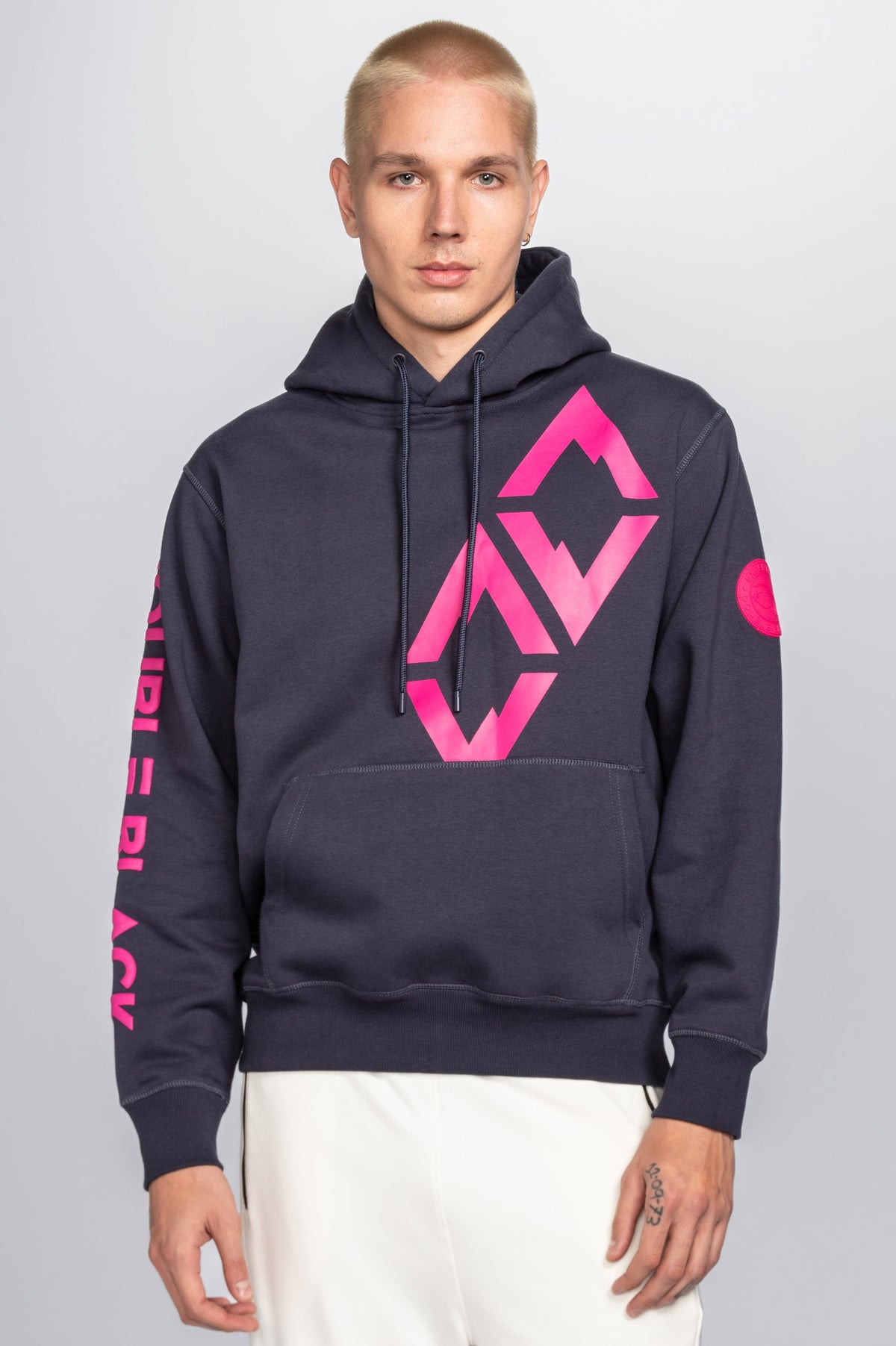 Model wearing Double Black Hoodie in navy and pink