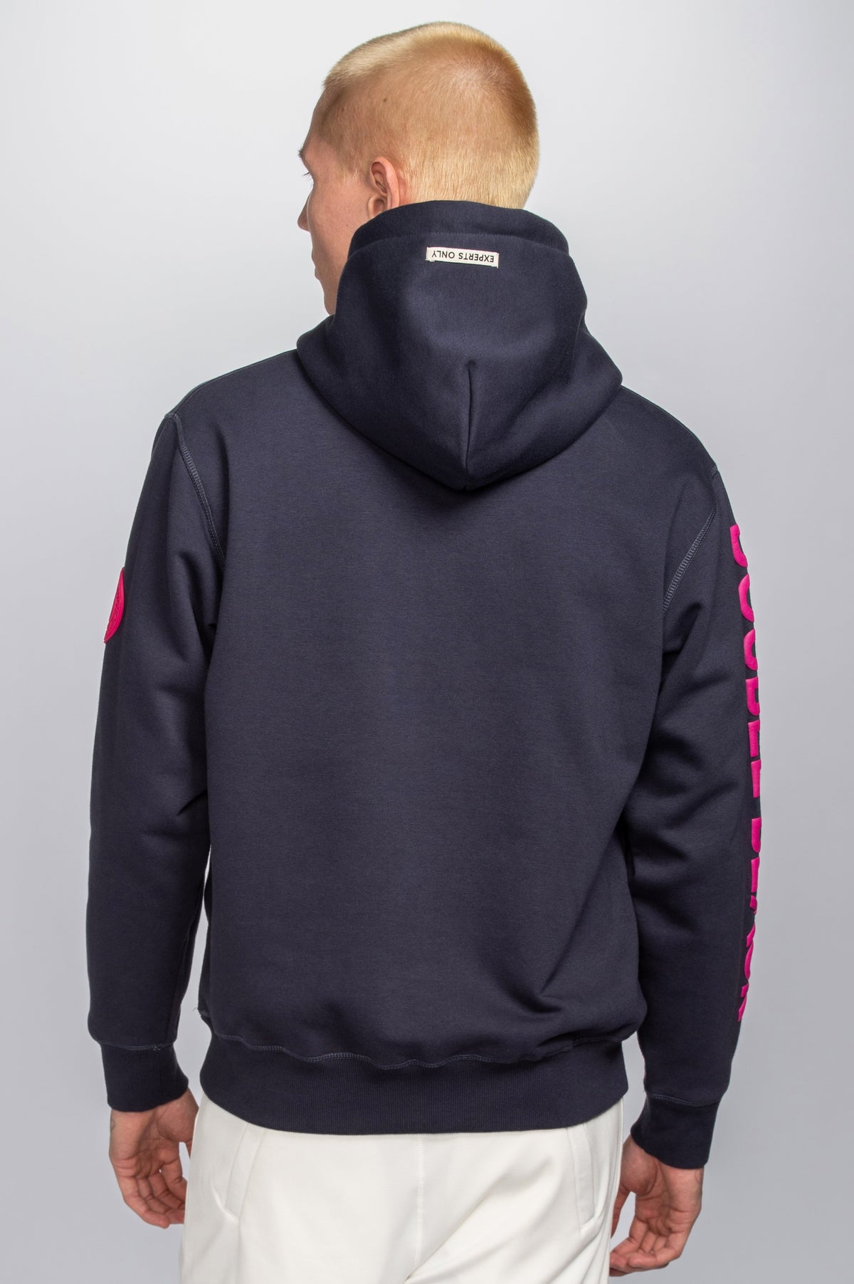 Model wearing Double Black Hoodie in navy and pink back view