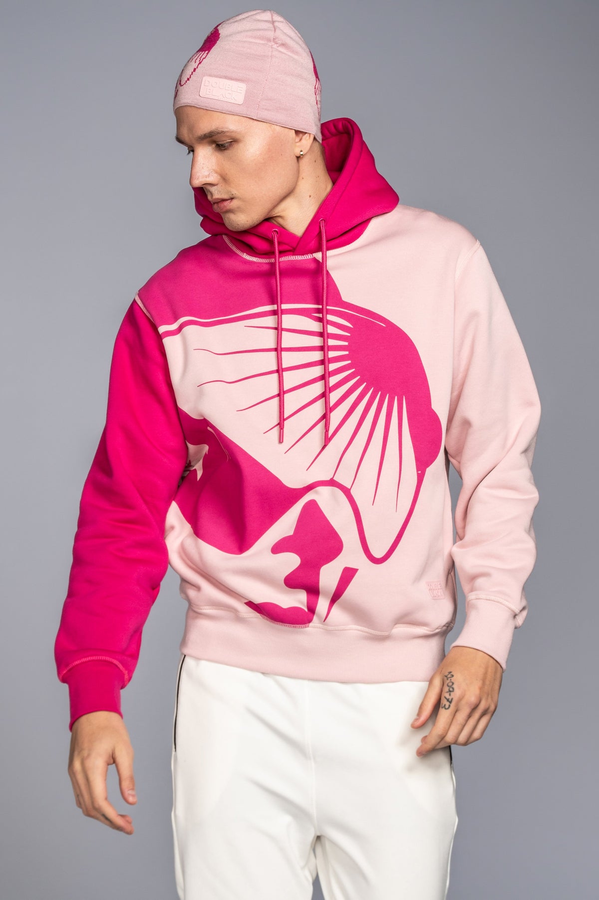Model wearing Double Black On The Mountain Hoodie in pink
