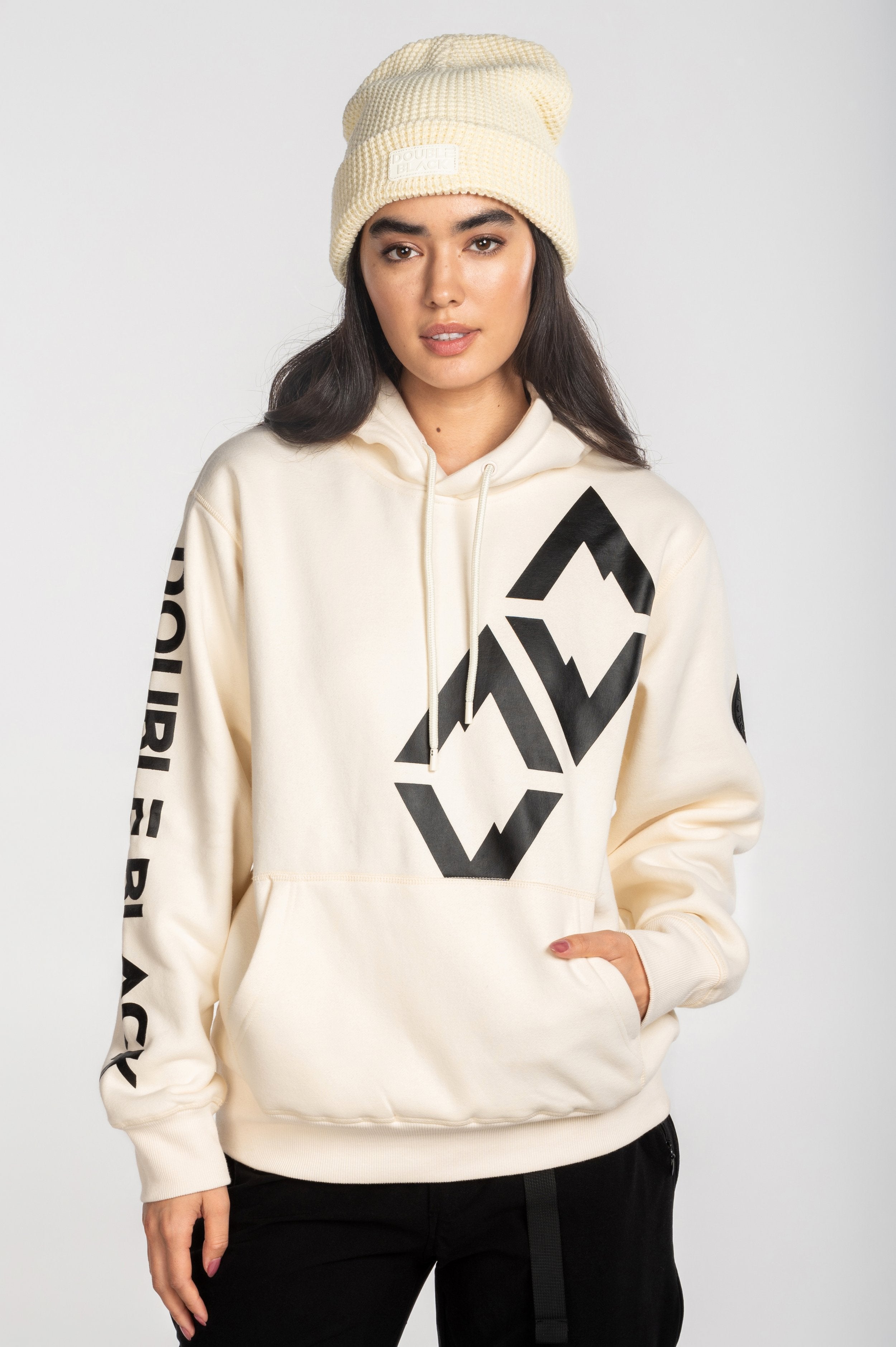 Model wearing Double Black Hoodie in cream