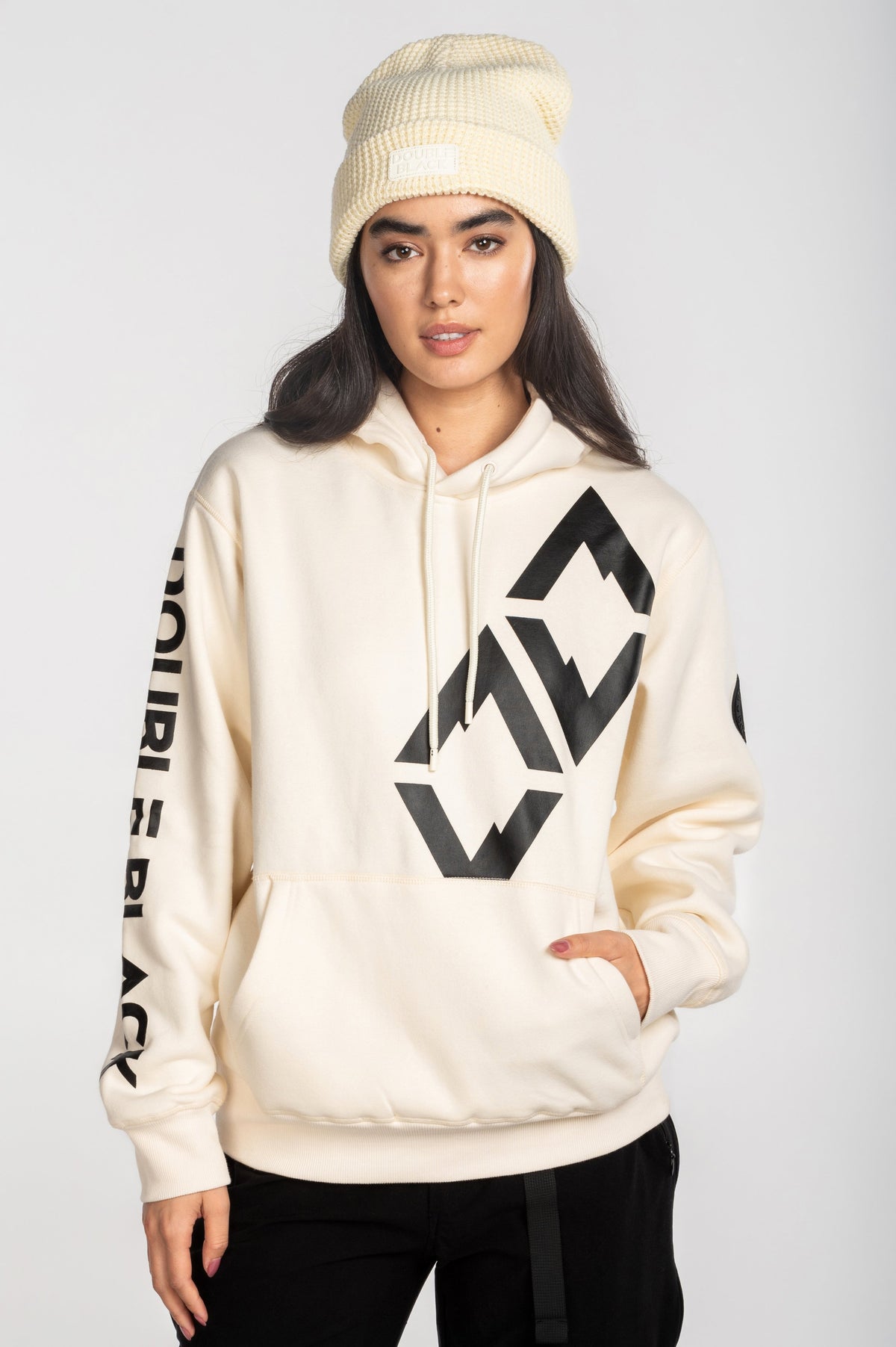 Model wearing Double Black Hoodie in cream