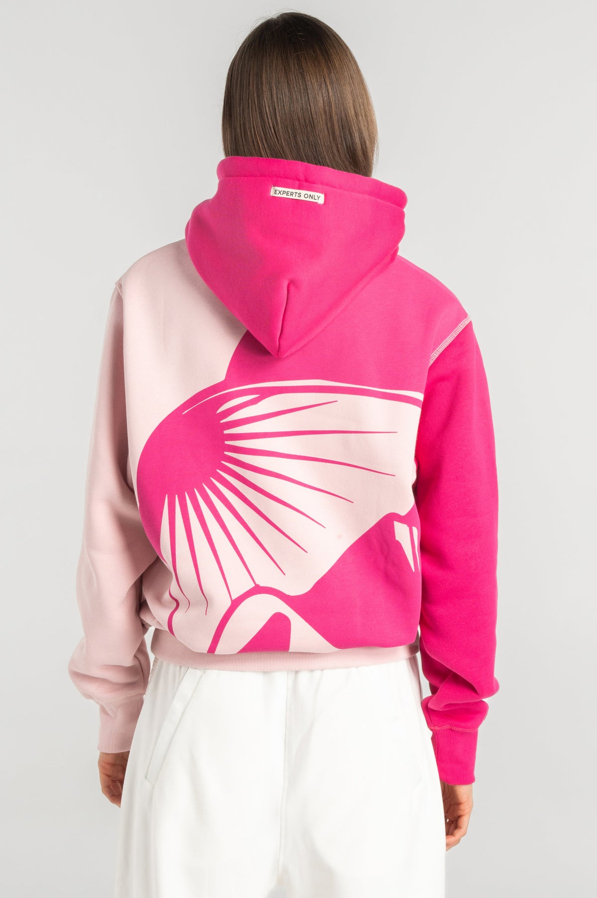 Model wearing Double Black On The Mountain Hoodie in pink back view