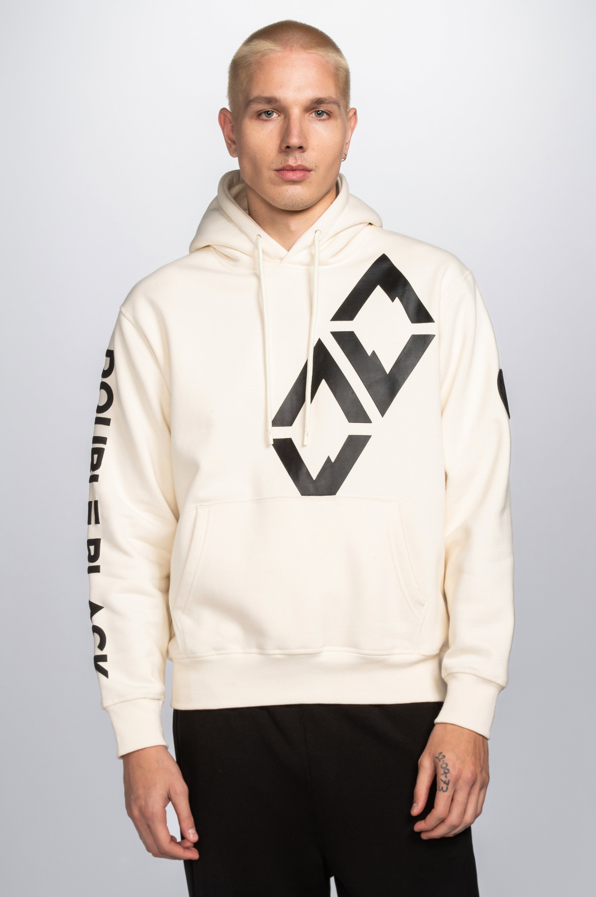 Model wearing Double Black Hoodie in cream