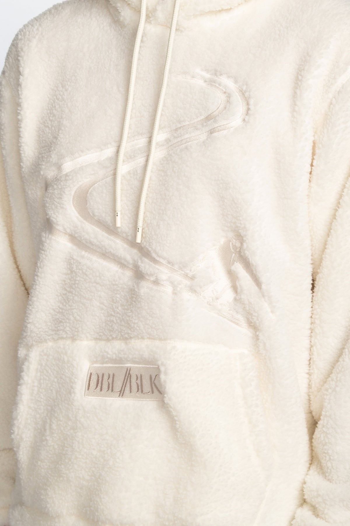 close up image of white Double Black Sherpa Hoodie skier graphic